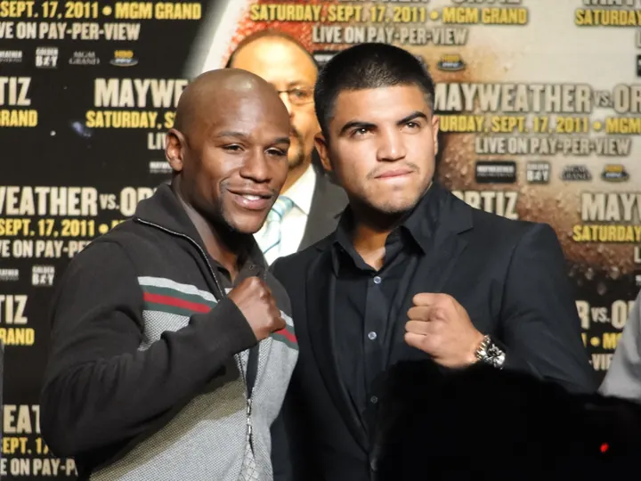 Floyd Mayweather Jr. and Victor Ortiz posing with fists raised