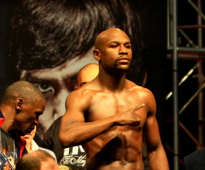 Floyd Mayweather Jr. flexing at the weigh-in